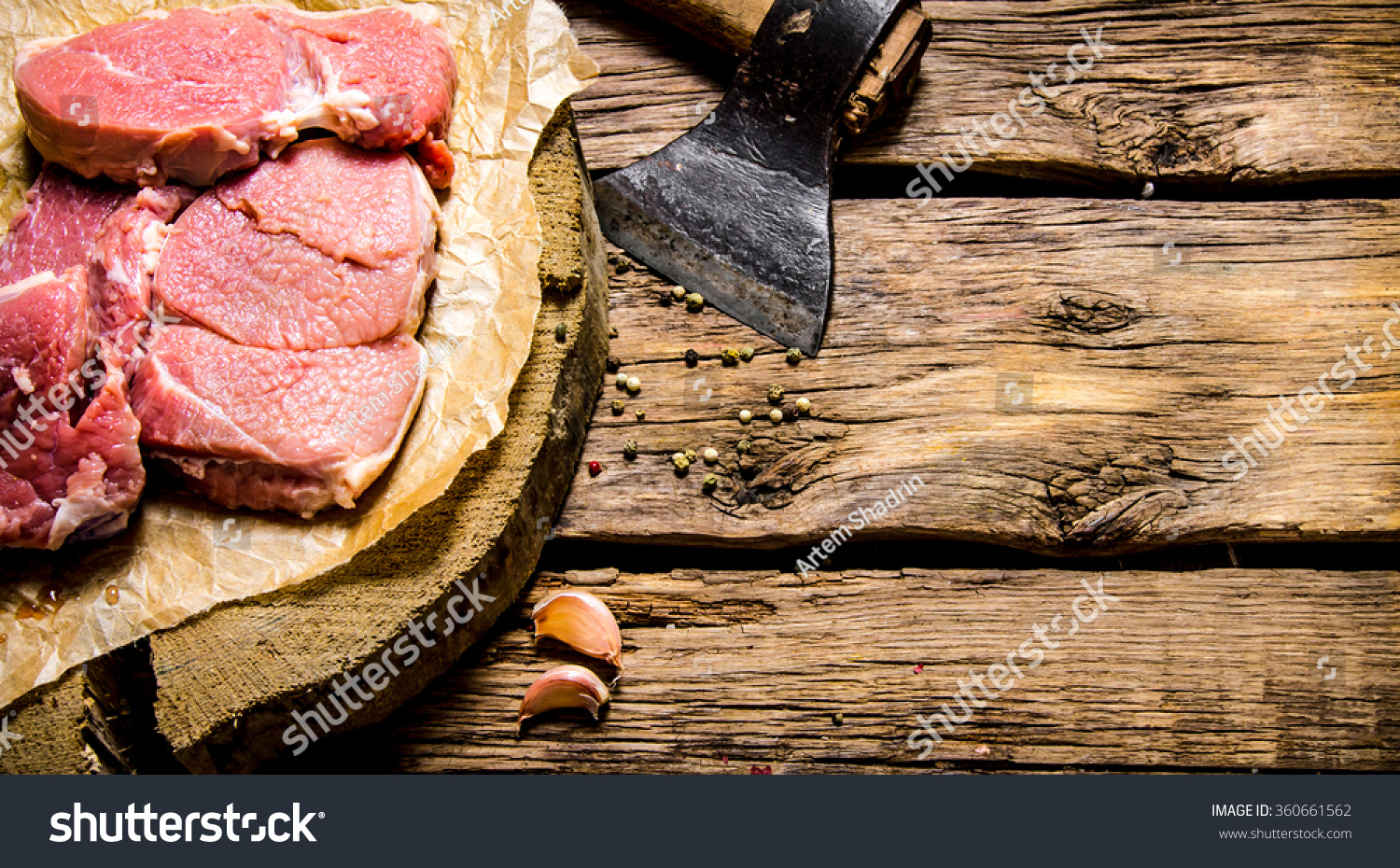 fresh raw minced meat with an axe. on a wooden table.